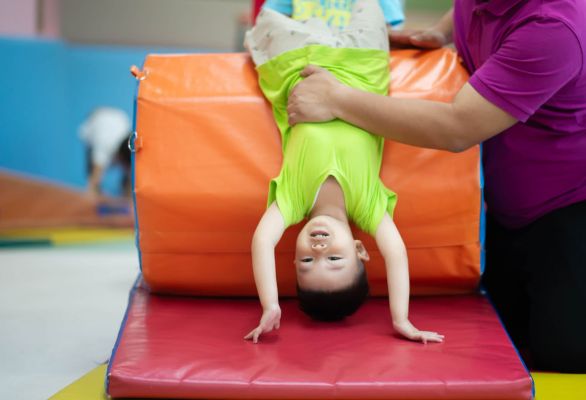 Little toddler boy working out at the indoor gym excercise